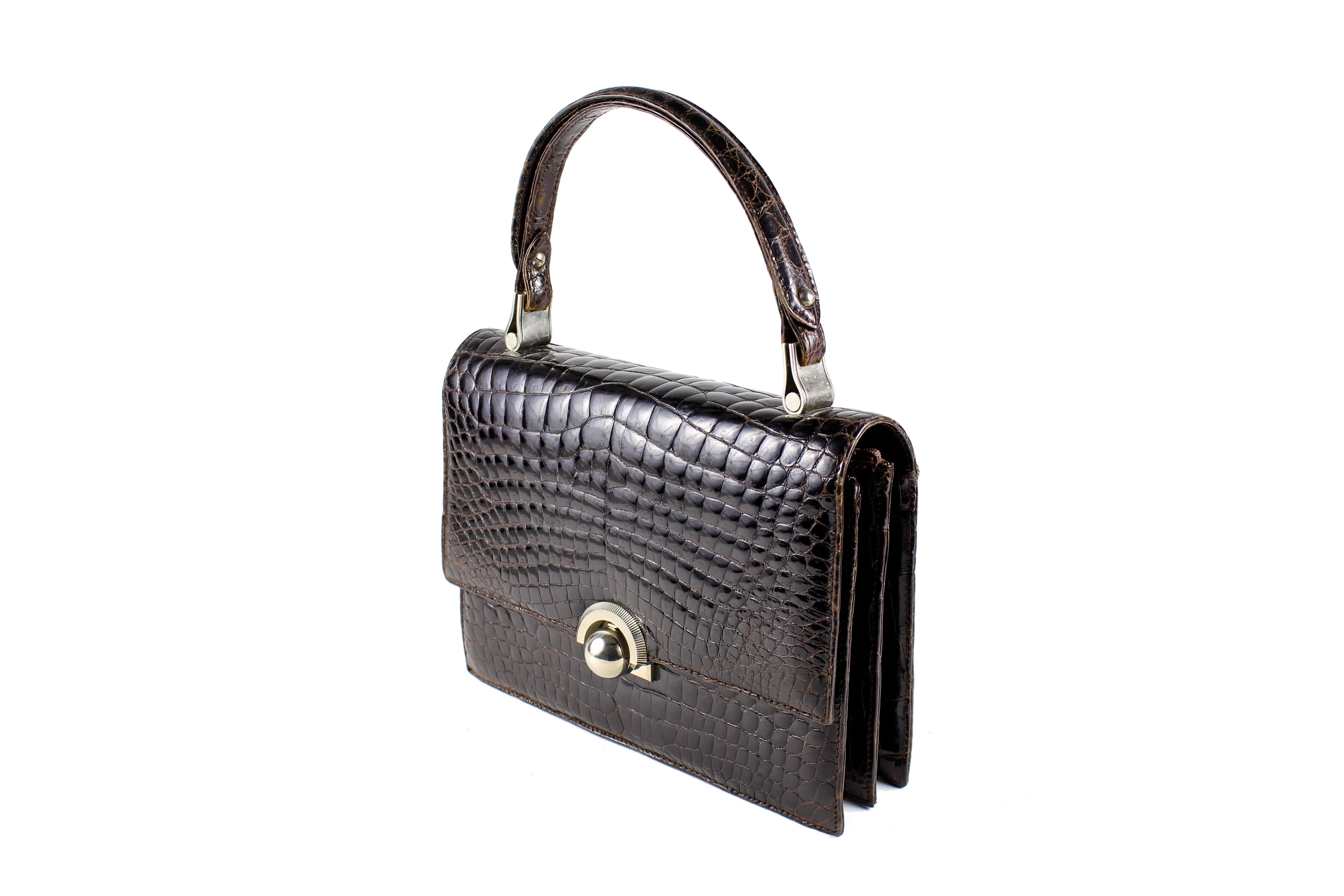 Brown crocodile skin handbag with flap and decorative clasp