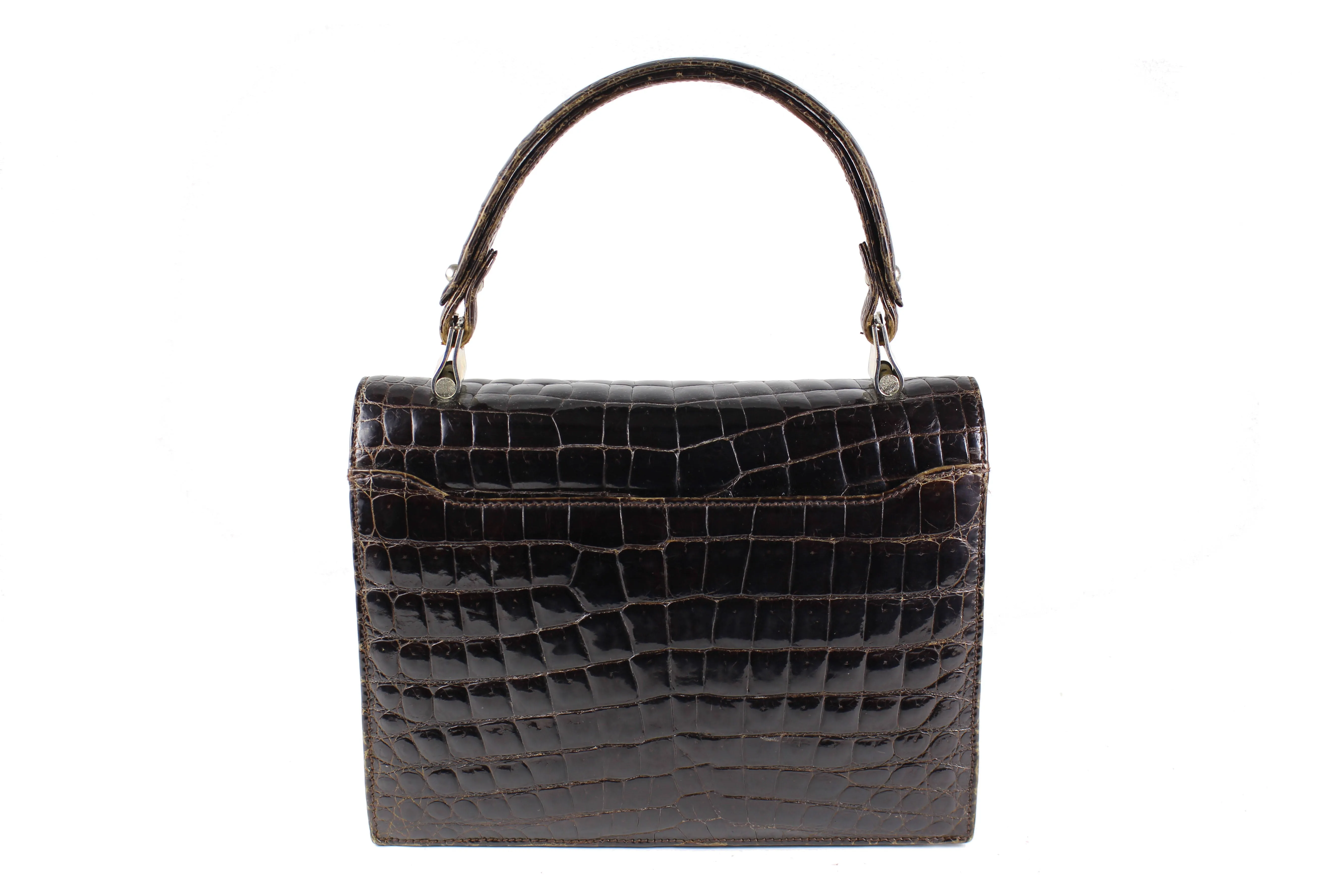 Brown crocodile skin handbag with flap and decorative clasp