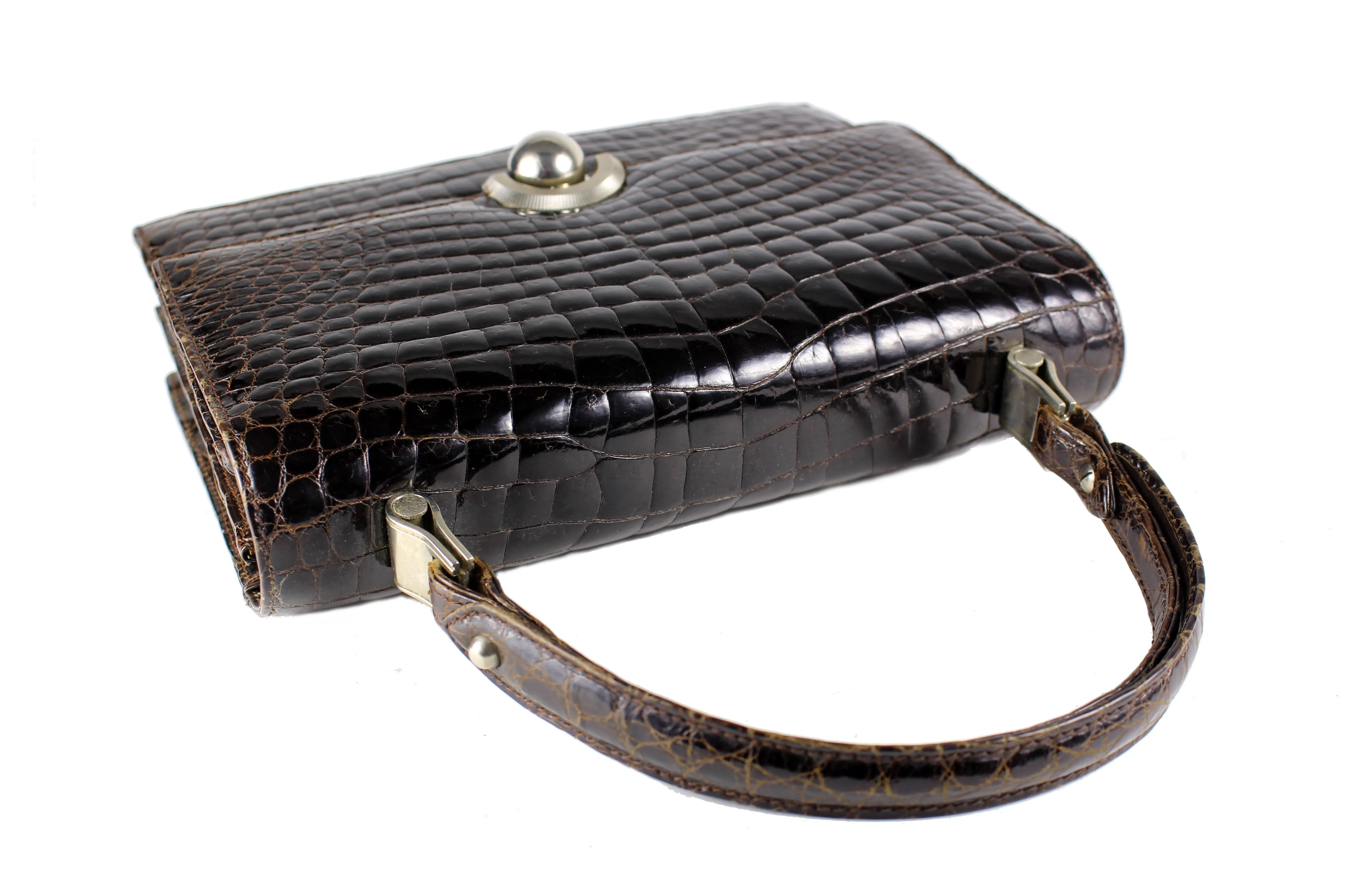 Brown crocodile skin handbag with flap and decorative clasp