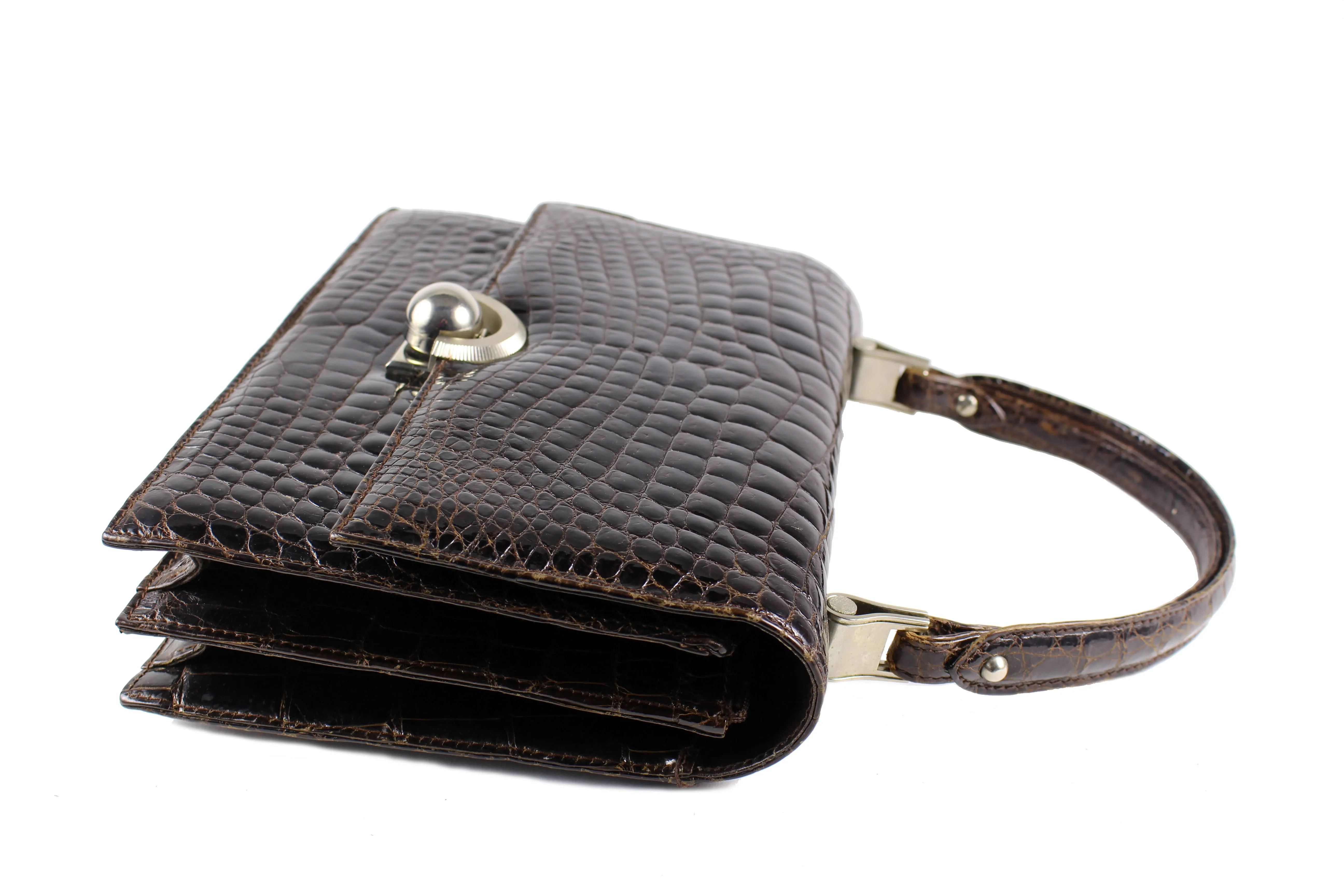 Brown crocodile skin handbag with flap and decorative clasp